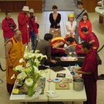 People watch the process of the sand mandala and butter sculptures