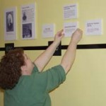 Jerrie Lee Parpart mounting the exhibit on the wall
