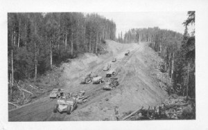 Reese & Olson Construction Company hauling in fill for the Muskwa Bridge. About 350,000 cubic yards were filled in on each side of the river. 150 feet wide at bottom and 50 feet high for nearly 1800 feet, then it tapers off.