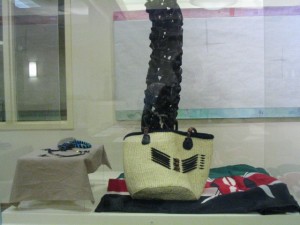 KENYA: Black wooden carving representing activities from village life (above) Woven basket (behind carving) Bead jewelry made by village women (left) ~ Courtesy loan from Francis Kamweti