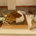 RUSSIA: Dome tent surrounded (from left to right) by birch bark basket, fishing lure, berry comb, cache, and whale vertebrae.